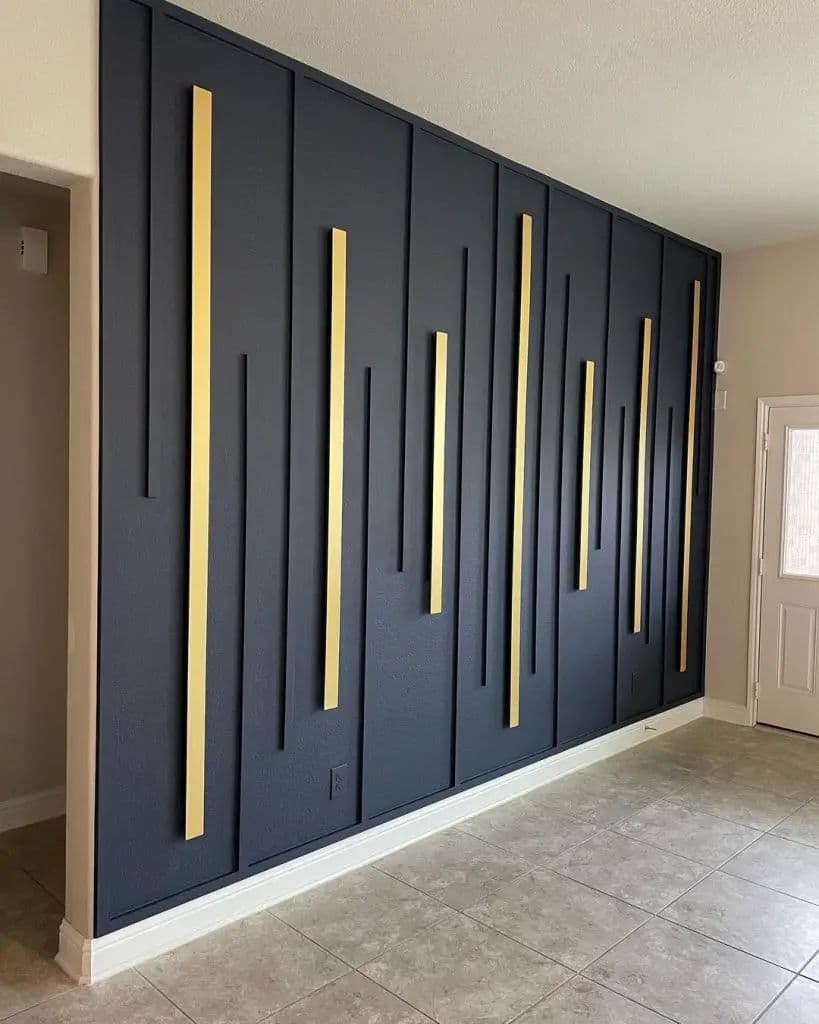 Modern black accent wall with gold vertical panels, a unique custom wallpaper installation.